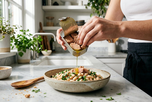 Tuna and white bean salad — tinned tuna with cannellini beans, red onion, flat-leaf parsley and lemon on a wide plate